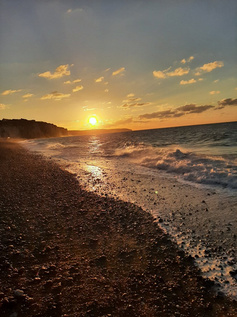 sunset picture taken in Dieppe, facing West, the sun just about to dip behind the cliffs